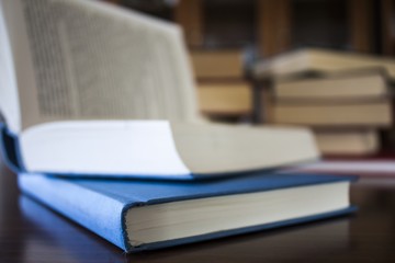 Many different sized colored and shaped books on wood table