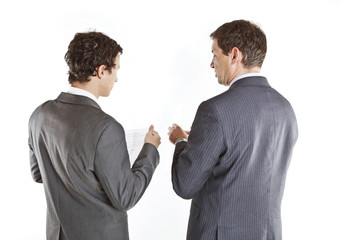 Two businessmen looking at documents