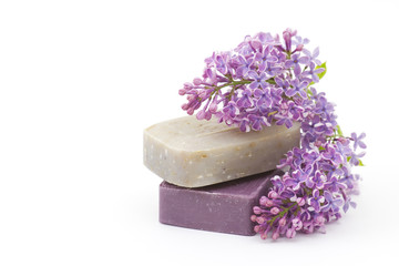 Obraz na płótnie Canvas two bars of natural soap and lilac flowers