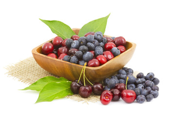 cherries and blueberries in a wooden bowl