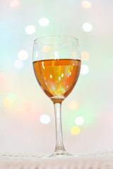Glass of White Wine with Lights Background