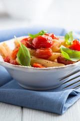 Penne pasta with cherry tomatoes and basil