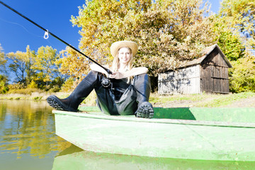 fishing woman sitting on boat