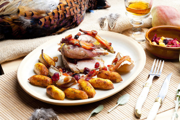 baked pheasant with bacon, pear, raisins on brandy