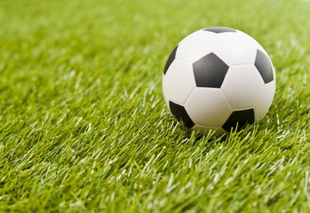 Fototapeta premium Football on the fake green grass