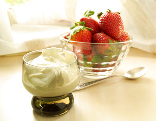 strawberries with cream cheese in a glass on the table