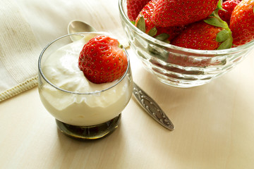 strawberries with cream cheese in a glass on the table
