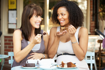 Pregnant women sitting outside café
