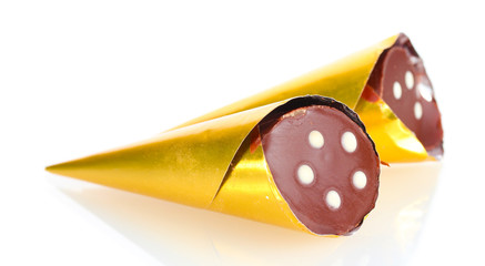 Сhocolate candy in the shape of a horn in the gold package