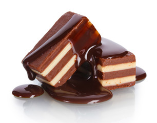 Сhocolate candy poured chocolate isolated on white