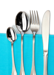 Fork, spoon and knife on a blue tablecloth