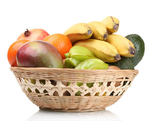 Assortment of exotic fruits in basket isolated on white