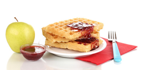 Tasty waffles with jam on plate isolated on white