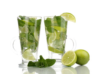 Glasses of cocktail with lime and mint isolated on white