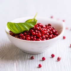Pink peppercorns and basil leaf