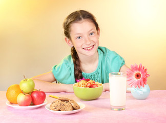 little beautiful girl have a breakfast on beige background