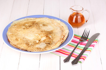 Stack of tasty pancakes on wooden background