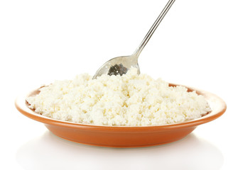 Spoon scoops of cottage cheese in a plate on white background