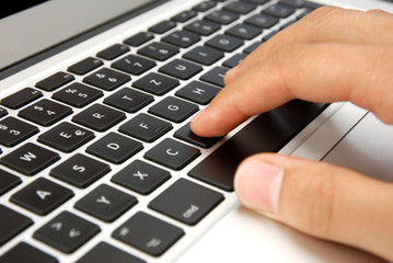 hand writing on laptop keyboard