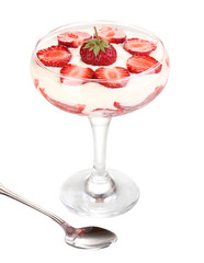 Glass of ripe strawberries with cream isolated on white