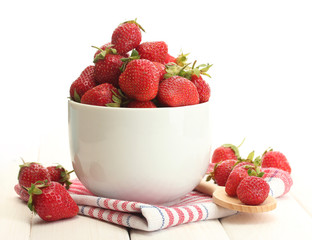 sweet ripe strawberries in bowl on white wooden table