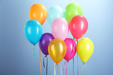 colorful balloons on blue background close-up