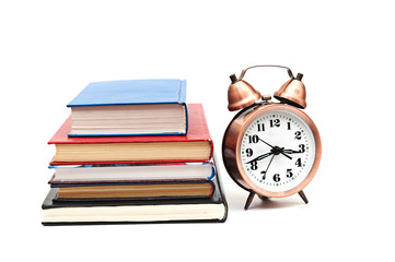 clock and books on a white background