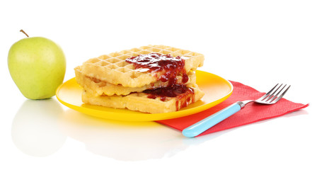 Tasty waffles with jam on plate isolated on white