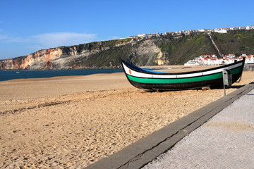 Naklejka na ściany i meble boat on the beach in nazare