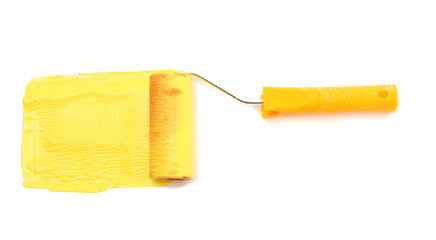 Paint roller with yellow paint isolated on white