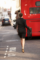 Fototapeta premium Businesswoman running for bus