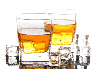 two glasses of scotch whiskey and ice on table isolated on