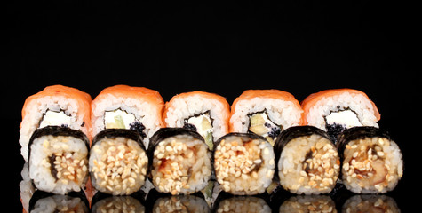 Tasty rolls in line isolated on black