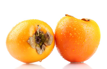 Two appetizing persimmons with droplets isolated on white