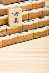 Old chinese game mahjongg on bamboo mat background