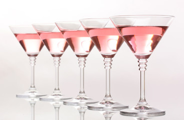 Red cocktail in martini glasses isolated on white