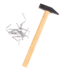 Hammer and metal nails isolated on white