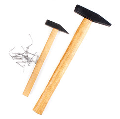 Hammers and metal nails isolated on white
