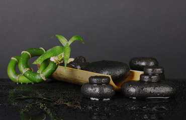 Composition of bamboo and spa stones isolated on black