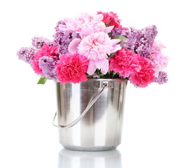 beautiful spring flowers in metal bucket isolated on white