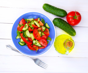 Fresh salad on white wooden background