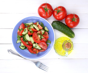 Fresh salad on white wooden background
