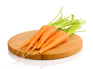 Carrots on wooden board isolated on white