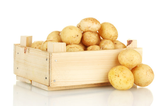 young potatoes in a wooden box isolated on white close-up