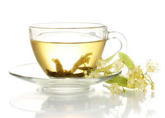 cup of linden tea and flowers isolated on white