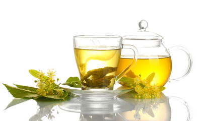 cup and teapot of linden tea and flowers isolated on white