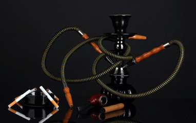 hookah, cigar, cigarette and pipe isolated on black