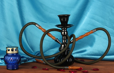 hookah on wooden table on cloth background