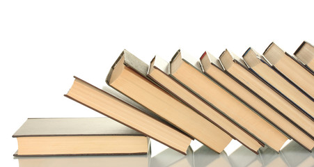 leaning stack of books on white background