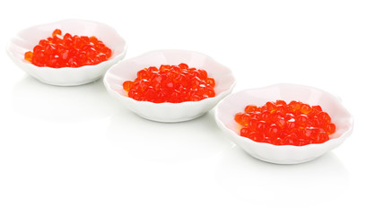 Red caviar in white bowls isolated on white